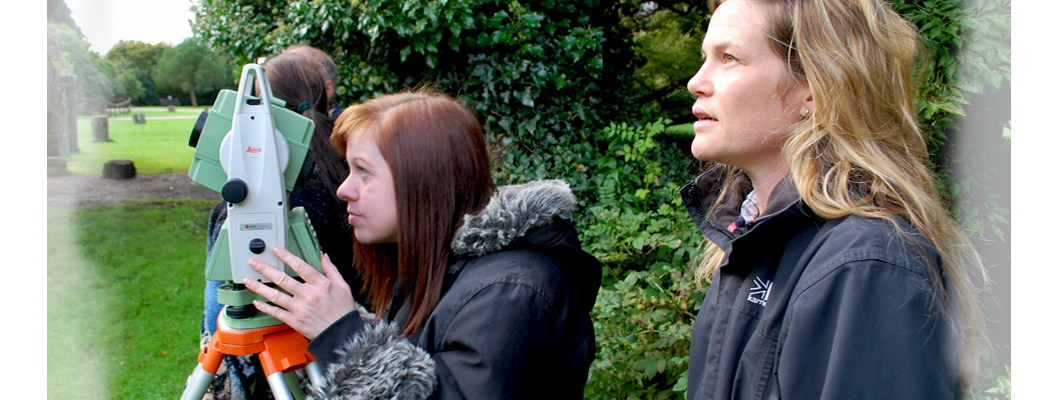 Volunteers using an EDM to record masonary at Margam Abbey