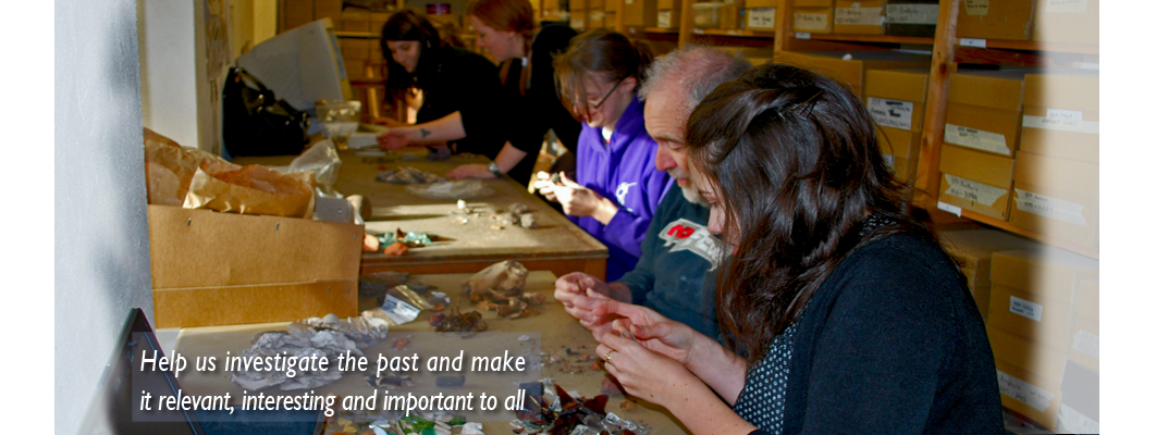 A group of GGAT volunteers of various ages sorting and recording pottery