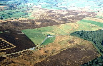 Late 18th and early 19th-century enclosure of former common and inn along early 19th-century turnpike on northern edge of moor.