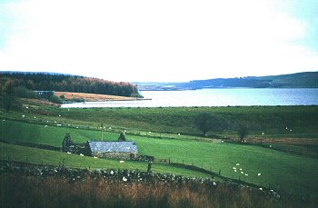 Large later 20th-century reservoir in broad valley towards the eastern edge of Mynydd Hiraethog superimposed upon a medieval and later landscape of farmsteads and fields.
