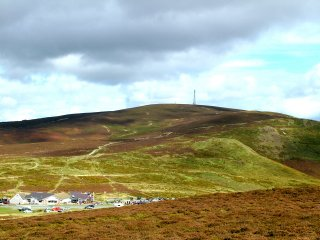 Unihabited upland moorland ridge mostly forming unenclosed common land, with prehistoric burial mounds, formerly partly managed as a grouse moor.