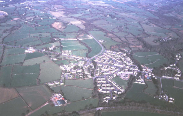 Aerial view of this nineteenth century ribbon development looking east, showing twentieth century housing estates added and the Welsh Highland Railway in the foreground.
