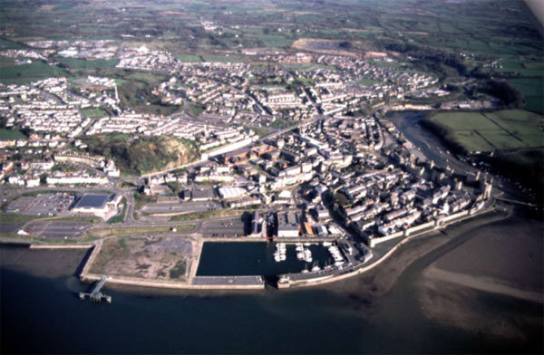 Aerial view of the town looking south, with the Victoria Dock in the foreground, the medieval castle and walled town to the right and the nineteenth and twentieth century expansion extending into the distance.
