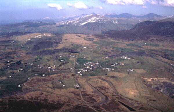 The open, nucleated settlement of Fron is visible in the centre of this aerial view which looks north east. ln the foreground is part of the impressive Cilgwyn tip railway, built to gain height and access to wider tipping space for the quarry.