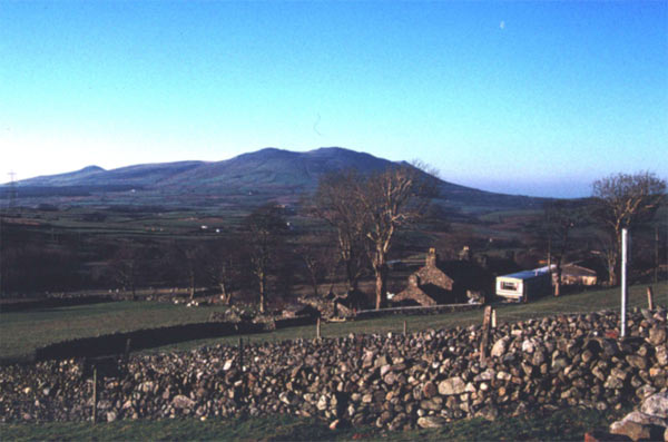 The principal characteristics of this area, regular stone-walled fields with dispersed cottage/farm settlements on sloping ground, are evident in this view which looks south west.
