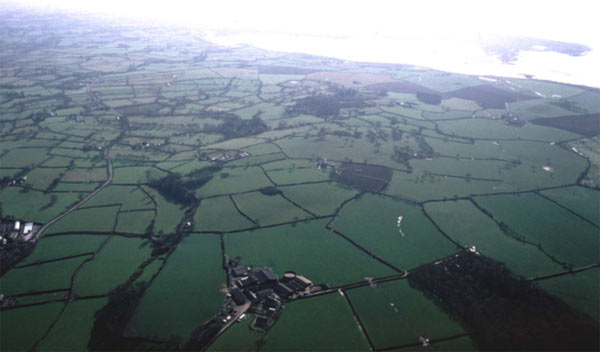 This small area, marked out by the underlying rock outcrop which has produced a distinctive pattern of small fields and winding lanes, is visible in the centre of this photograph which looks south west.
