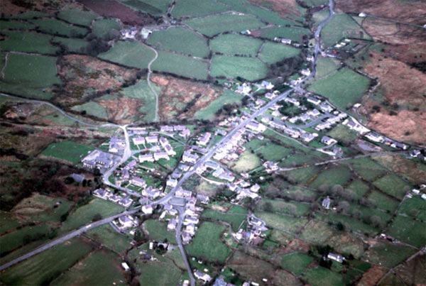 This aerial view of Rhostryfan, looking east, shows the relatively dense nucleation of the settlement, again set mainly along the road, and surrounded by the marginal fields of area 25 which contain so much important relict archaeology.