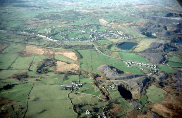 The 'ribbon' nature of this quarrying settlement is evident in this photograph which looks north, as it stretches from upper left to centre right, mainly following the line of the turnpike and the Nantlle railway. Some of the quarries are shown to the right of the photograph