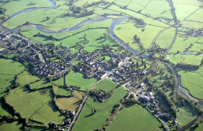 Modern village, originating as a medieval borough, overlying a Roman civilian settlement alongside a Roman fort, which owes its development initially to its position on the road and rail networks of the later 18th and 19th centuries and latterly as a dormitory village for Newtown.