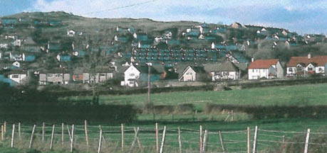 SH 814814 looking north. Showing the different characters of Penrhyn Bay , with the older, organically evolved settlement on top of the ridge and the recent, planned estates and housing below.