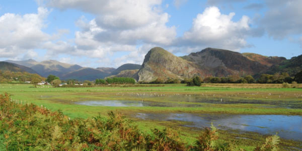 The crag of Craig yr Aderyn dominates the landscape of the upper valley