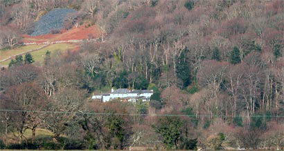 An eighteenth-century farmhouse transformed by William Alexander Madocks into the first Regency house in north-west Wales. The site was chosen chiefly for the view and in order to accommodate the larger house the hillside behind was cut back, leaving an exposed rock face. Stables and outbuildings are a short distance to the west.