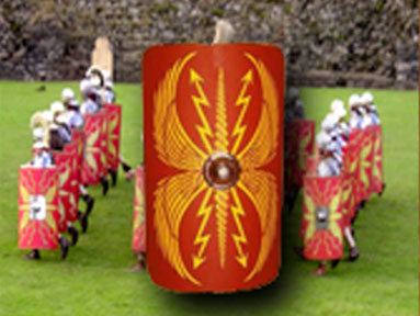 Roman re-enactors in formation holding large red shields decorated with yellow lightning motifs, with one shield shown prominently in the foreground.